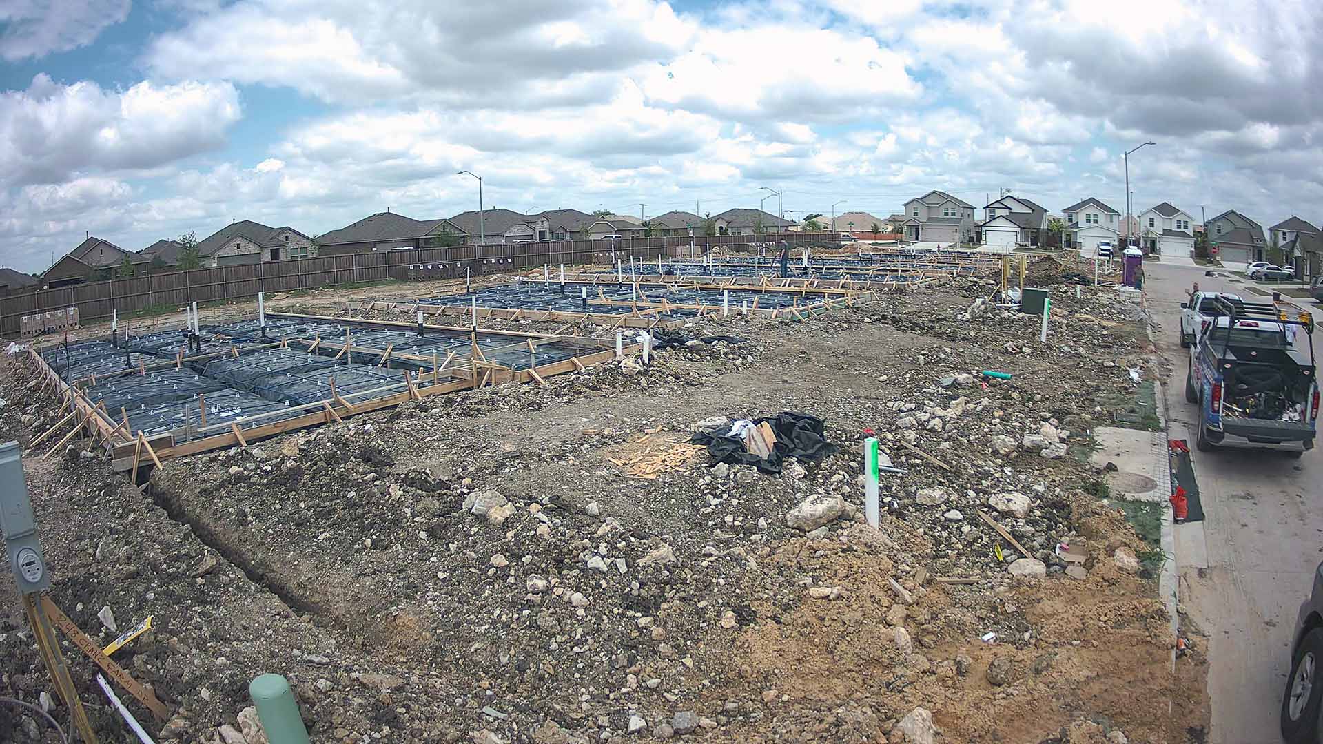 Residential subdivision under construction with homes in various build stages